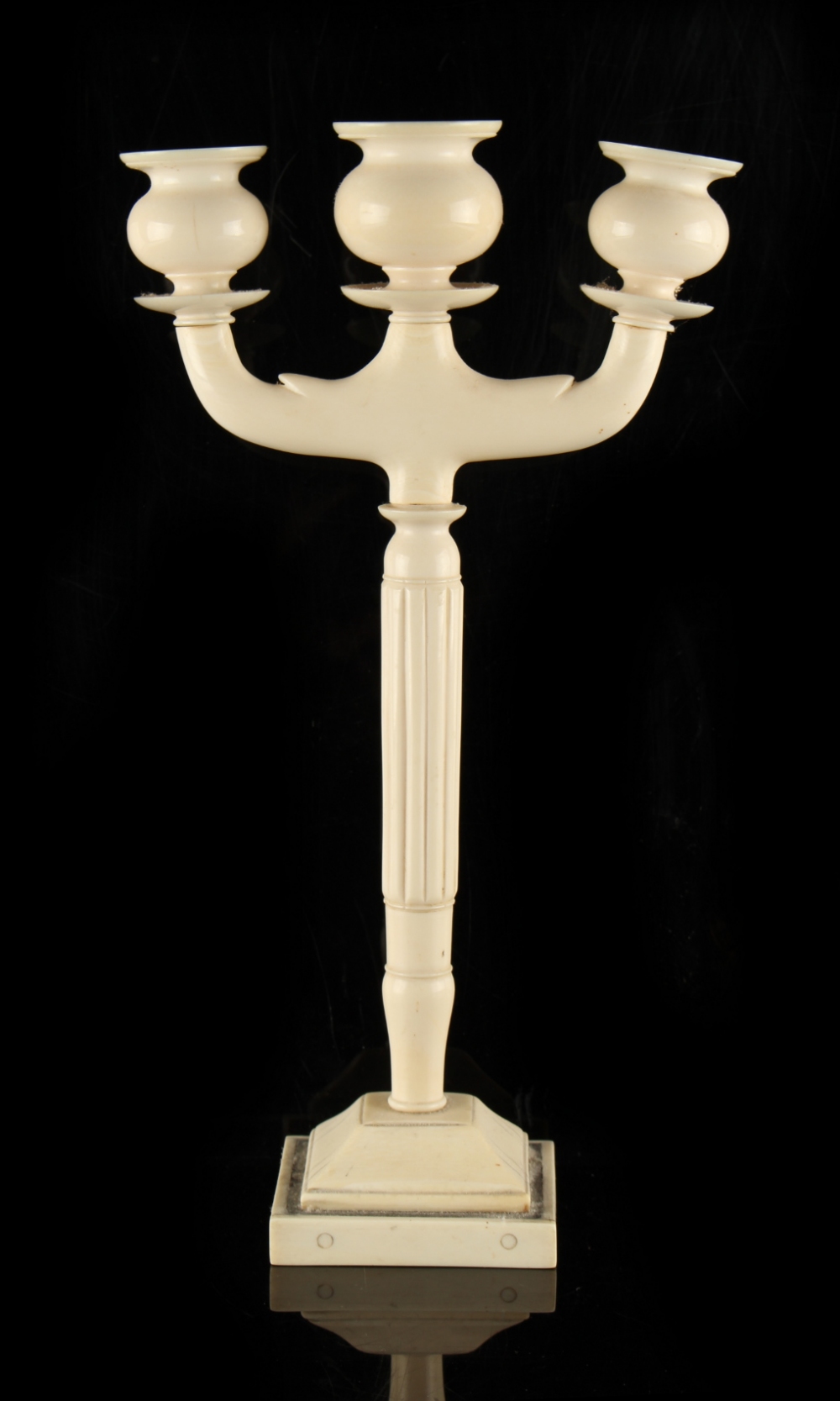 Property of a gentleman - an early 20th century Indian ivory three light candelabrum, 12.4ins. (31.
