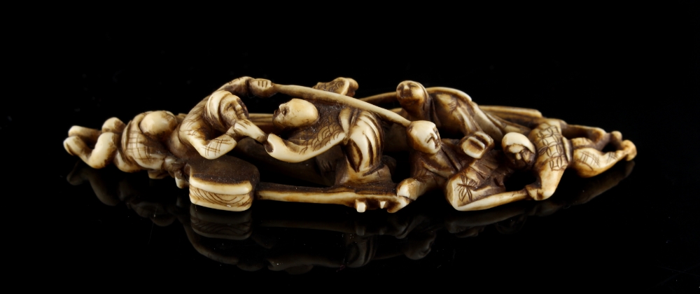 The Ronald Hart Collection of Japanese Netsukes - a carved ivory okimono modelled as seven