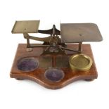 Property of a lady - a set of late Victorian brass parcel postal scales, the oak base 14.55ins. (