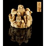 The Ronald Hart Collection of Japanese Netsukes - a carved ivory netsuke modelled as a group of five