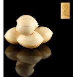 The Ronald Hart Collection of Japanese Netsukes - a carved ivory okimono modelled as a cluster of