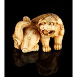 The Gill Collection of Japanese Netsukes - a carved ivory netsuke modelled as a recumbent