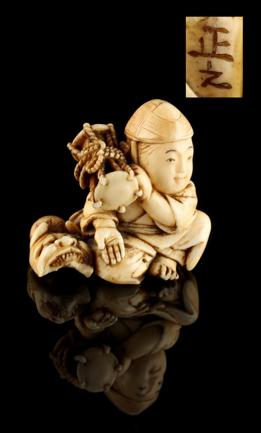 The Ronald Hart Collection of Japanese Netsukes - a carved ivory netsuke modelled as a seated boy