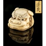 The Gill Collection of Japanese Netsukes - a carved ivory netsuke modelled as a karashishi mask,