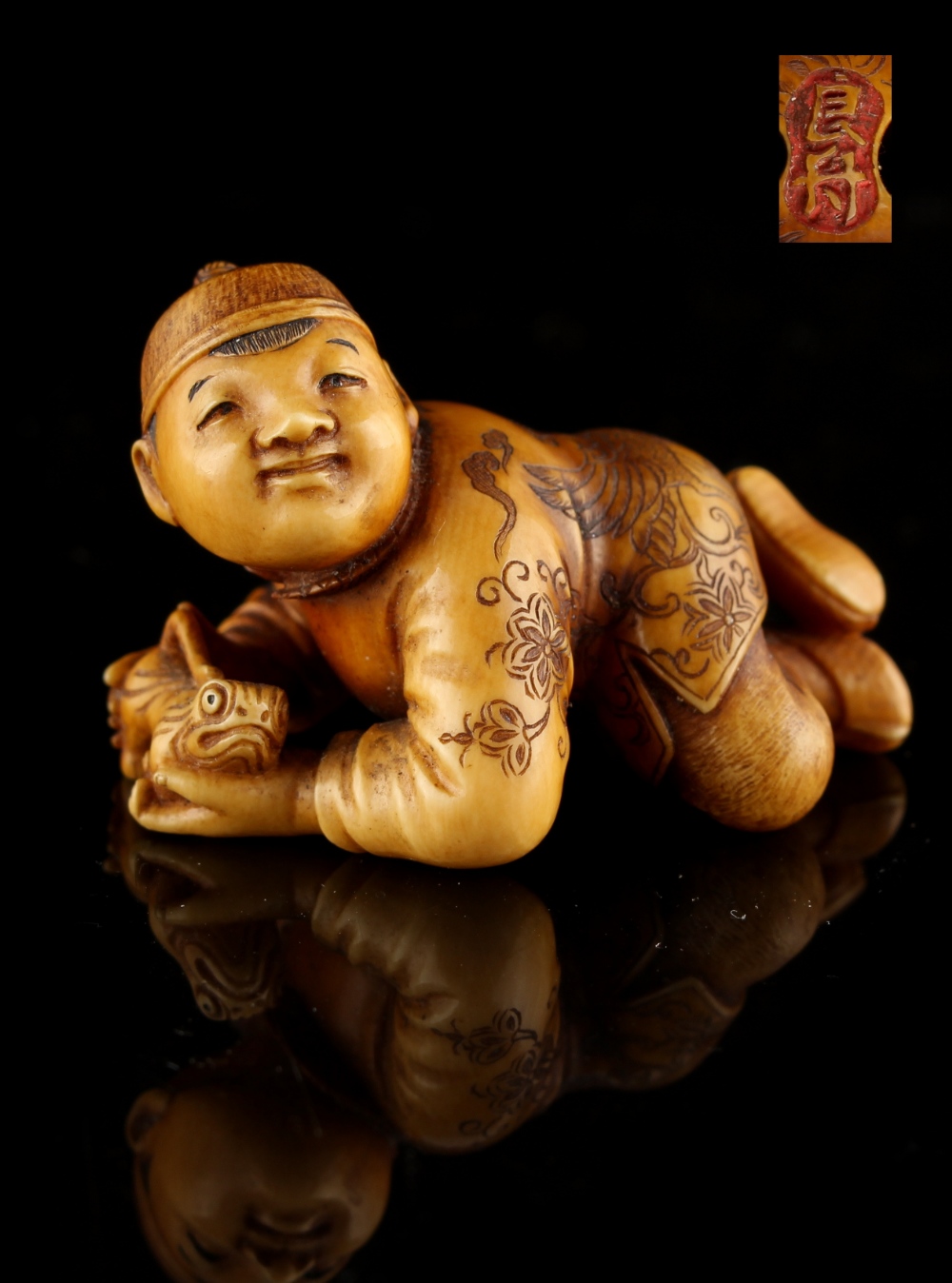 The Ronald Hart Collection of Japanese Netsukes - a carved ivory netsuke modelled as a recumbent boy