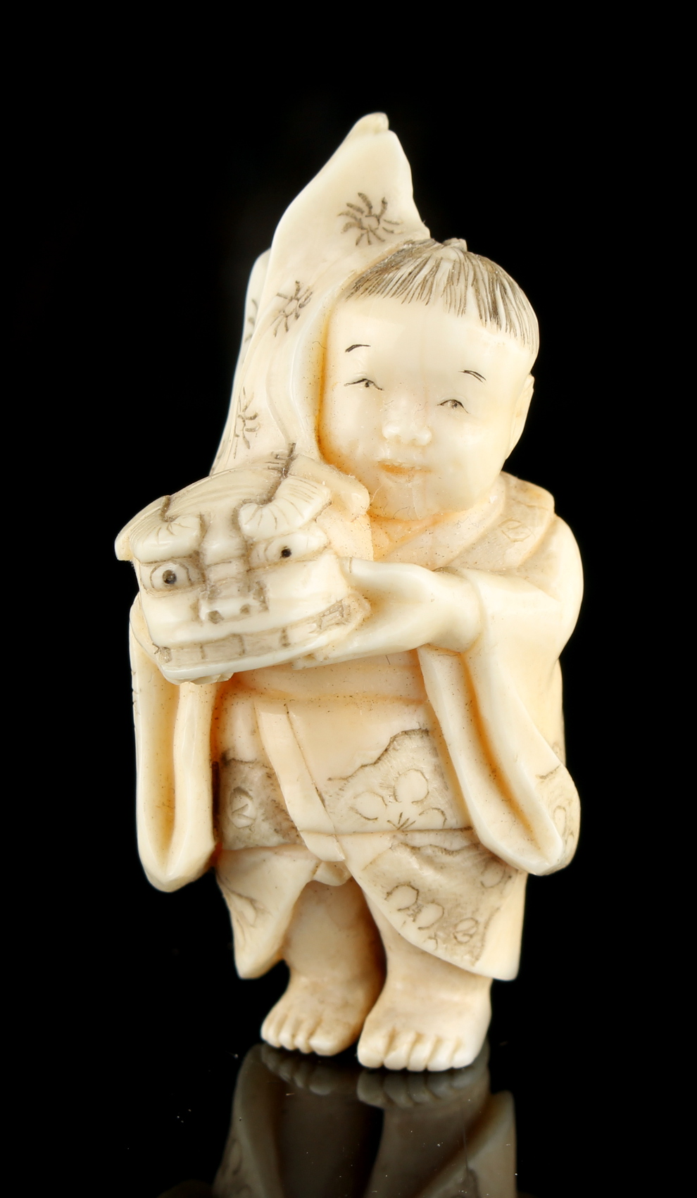 The Ronald Hart Collection of Japanese Netsukes - a carved ivory netsuke modelled as a boy