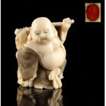 The Ronald Hart Collection of Japanese Netsukes - a carved ivory netsuke modelled as Hotei, signed