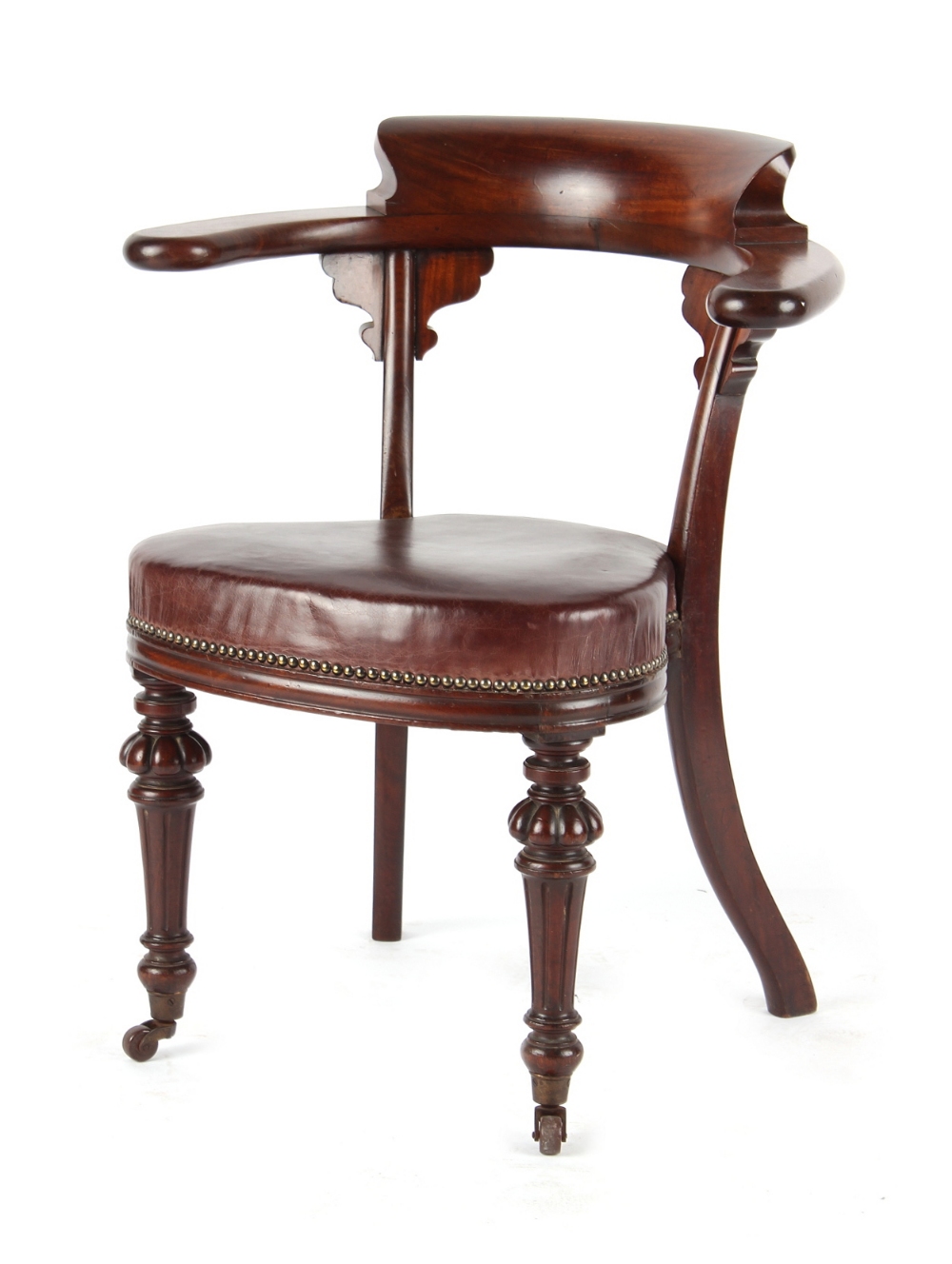 A Victorian mahogany desk chair, with yoke shaped back & turned front legs terminating in castors (