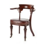 A Victorian mahogany desk chair, with yoke shaped back & turned front legs terminating in castors (