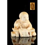 The Ronald Hart Collection of Japanese Netsukes - a carved ivory netsuke modelled as a seated boy