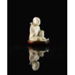 Property of a lady - a Chinese carved ivory figure of a Lohan, 19th century, modelled seated on