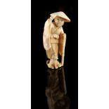 The Ronald Hart Collection of Japanese Netsukes - a carved ivory netsuke modelled as a standing