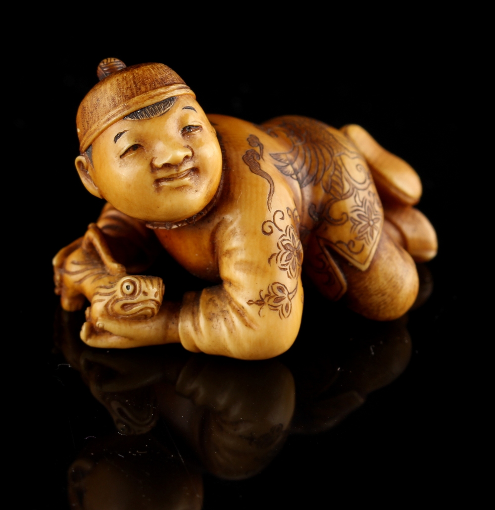 The Ronald Hart Collection of Japanese Netsukes - a carved ivory netsuke modelled as a recumbent boy - Image 6 of 8