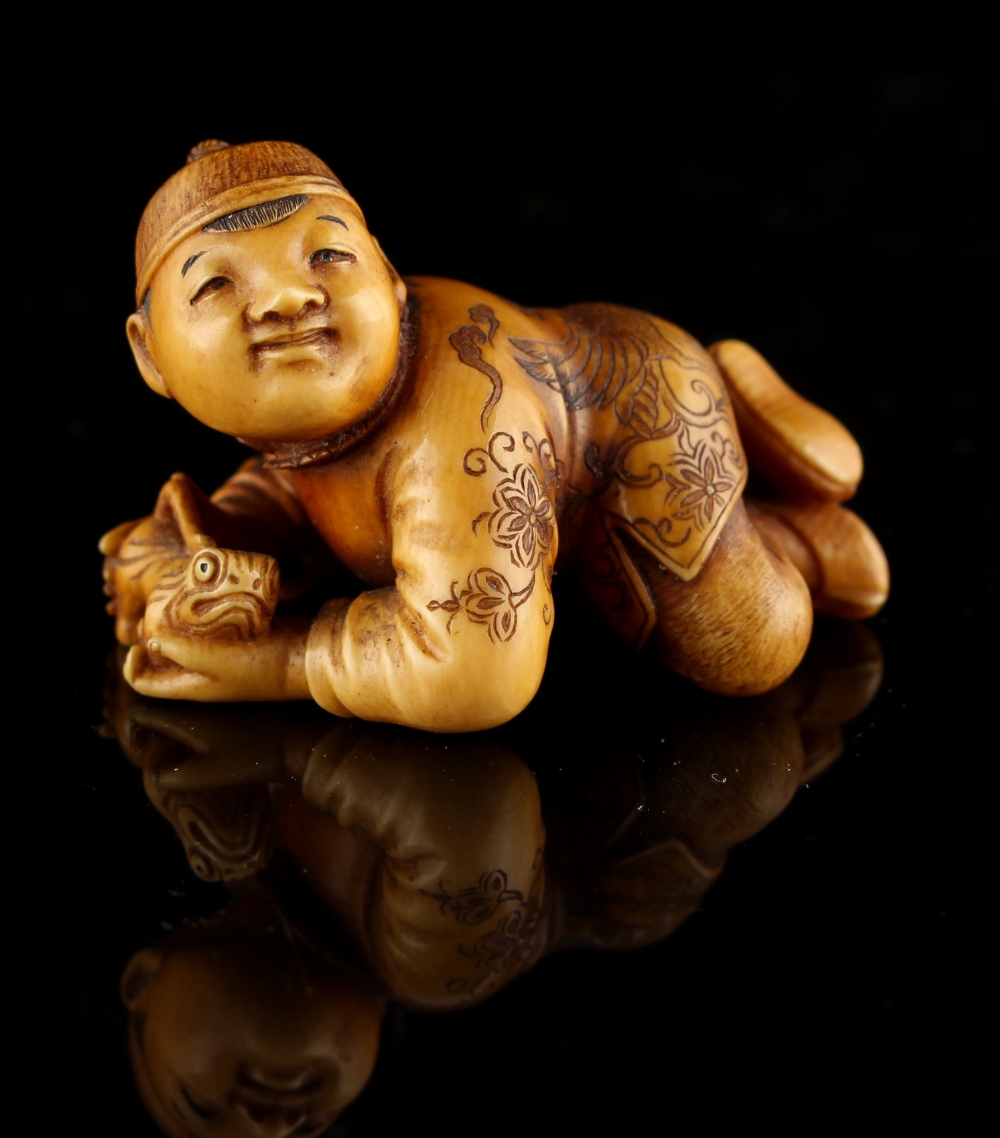 The Ronald Hart Collection of Japanese Netsukes - a carved ivory netsuke modelled as a recumbent boy - Image 7 of 8