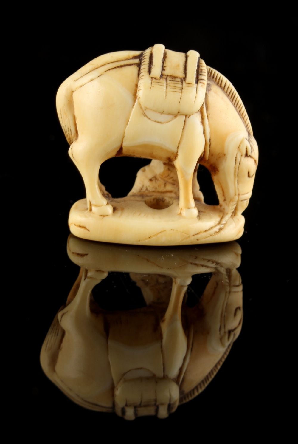 The Ronald Hart Collection of Japanese Netsukes - a carved ivory netsuke modelled as a boy seated by - Image 2 of 3