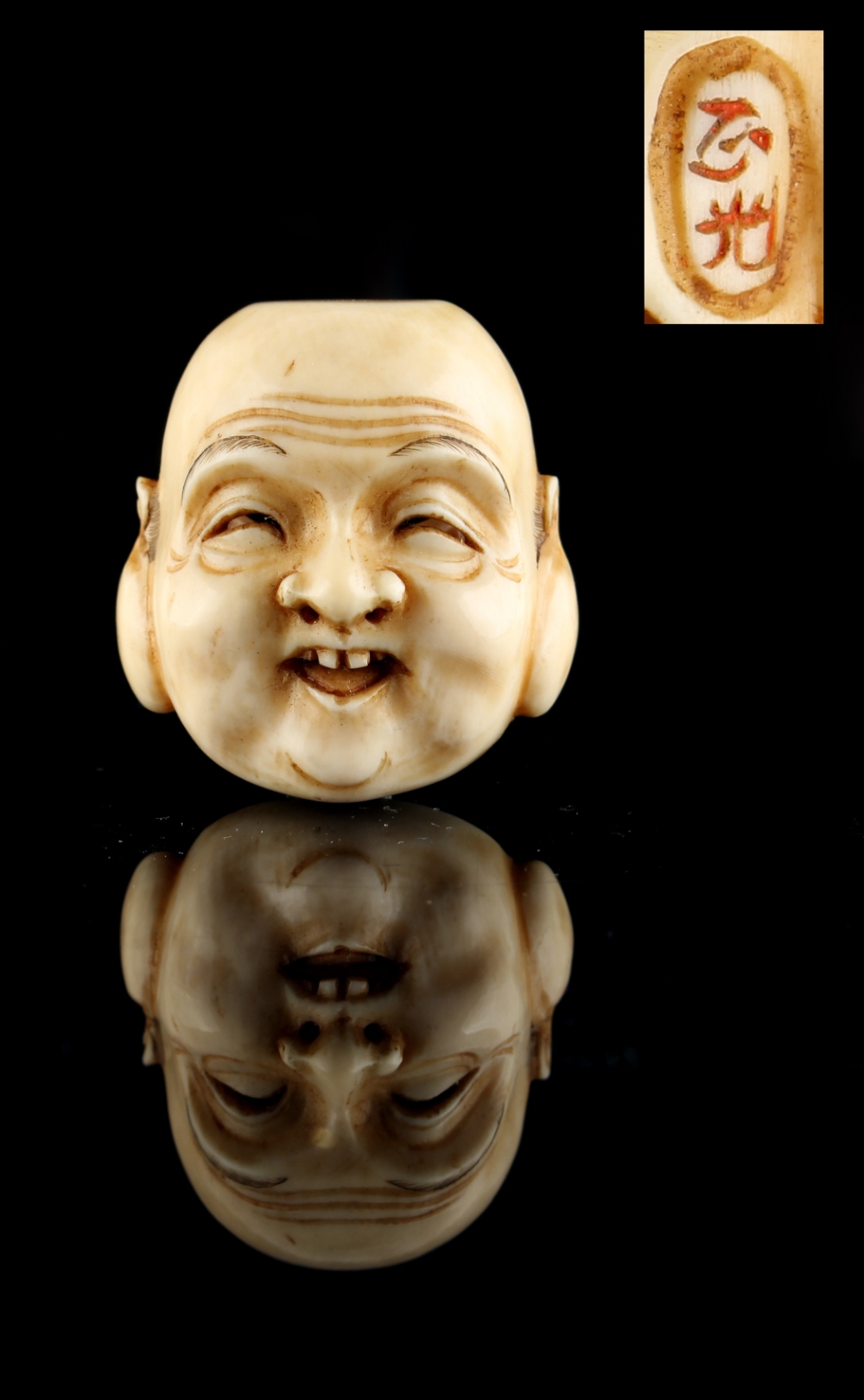 The Ronald Hart Collection of Japanese Netsukes - a carved ivory netsuke modelled as a mask of