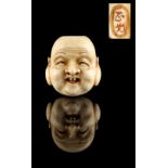 The Ronald Hart Collection of Japanese Netsukes - a carved ivory netsuke modelled as a mask of