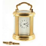 Property of a gentleman - a French L'Epee brass miniature oval carriage clock timepiece, 20th