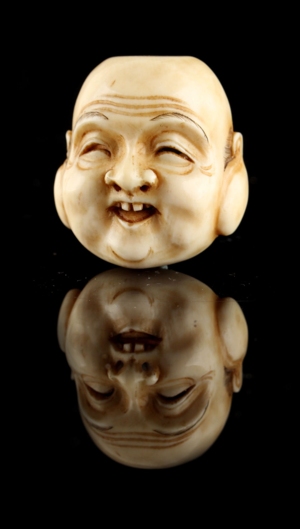 The Ronald Hart Collection of Japanese Netsukes - a carved ivory netsuke modelled as a mask of - Image 4 of 6