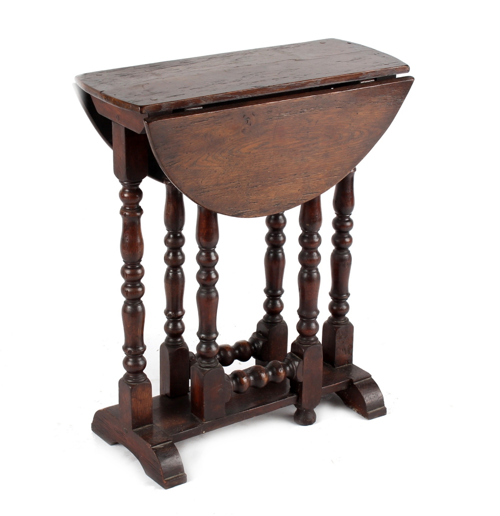 Property of a lady - an oak oval topped gate-leg table, 20th century, 23.8ins. (60.5cms.) long (