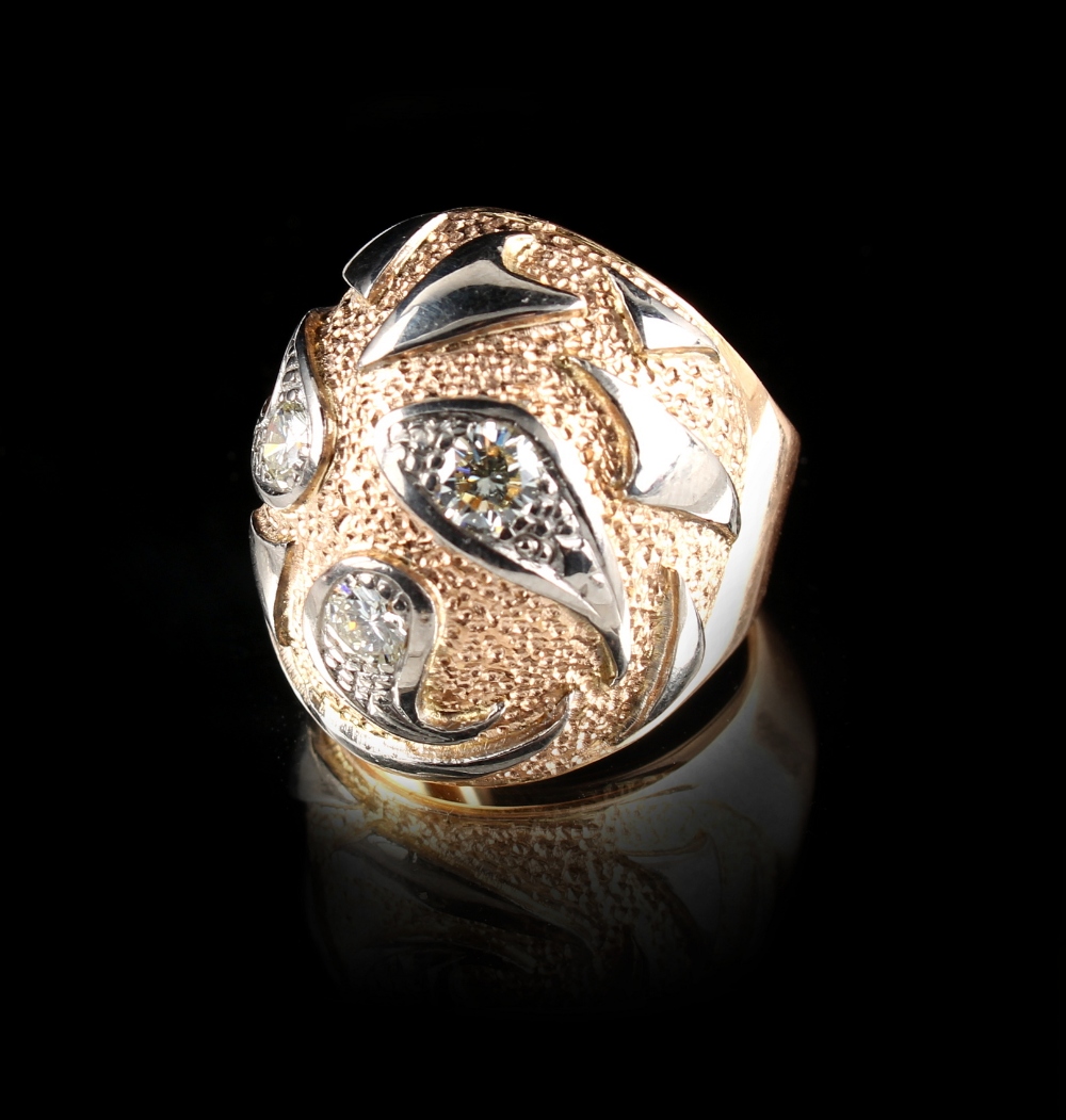 A modern 18ct three colour gold diamond ring, set with three round brilliant cut diamonds, the