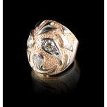 A modern 18ct three colour gold diamond ring, set with three round brilliant cut diamonds, the