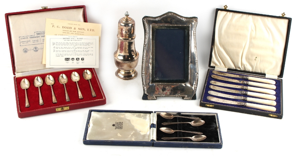 Property of a lady - a mixed lot of silver comprising a sugar caster, a photograph frame, a cased