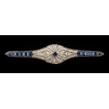 An Art Deco unmarked white gold or platinum sapphire & diamond brooch, with calibre cut
