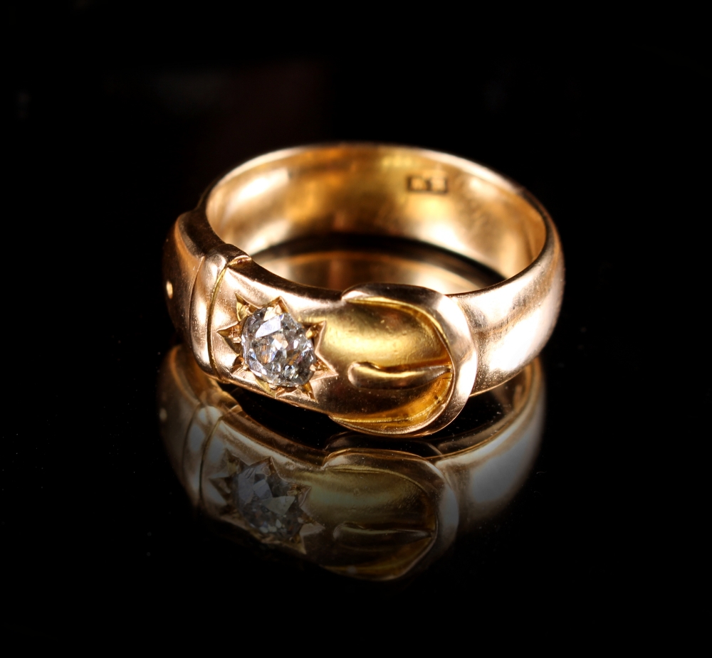 A heavy 18ct gold buckle ring set with an Old European cut diamond weighing approximately 0.44