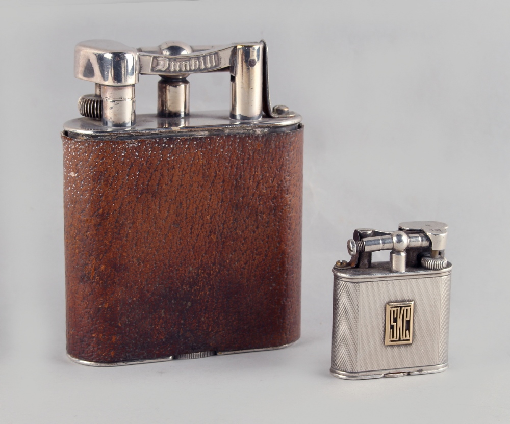 Property of a lady - a large Dunhill table lighter, with leather cover, 4.25ins. (10.8cms.) high;