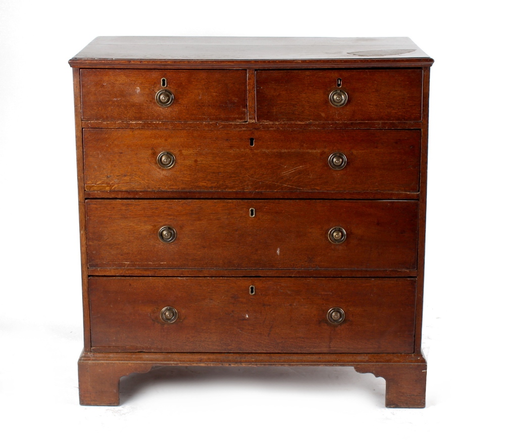 Property of a deceased estate - a George III oak chest of two short & three long graduated