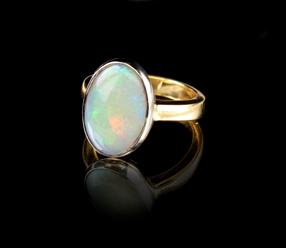An 18ct yellow gold opal ring, the oval opal weighing approximately 4.56 carats, approximately 8.4