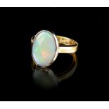 An 18ct yellow gold opal ring, the oval opal weighing approximately 4.56 carats, approximately 8.4