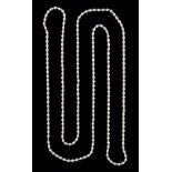 A long single strand pearl necklace, with alternating smaller pink & larger white pearls, the