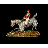 An unusual diamond & enamel horse & jockey brooch modelled as a steeplechaser jumping a fence,