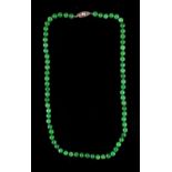 A Chinese jadeite bead necklace, the seventy individually knotted beads each approximately 5.8mm