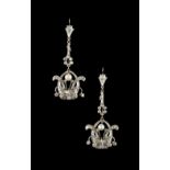 An unusual pair of unmarked white gold or platinum diamond long pendant earrings, each modelled as a