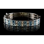 An Art Deco style 9ct white gold aquamarine & diamond hinged bangle, with two rows of alternating