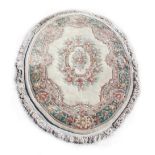 Property of a gentleman - a Chinese woollen hand-made oval rug with ivory ground, 96ins (244cms.)