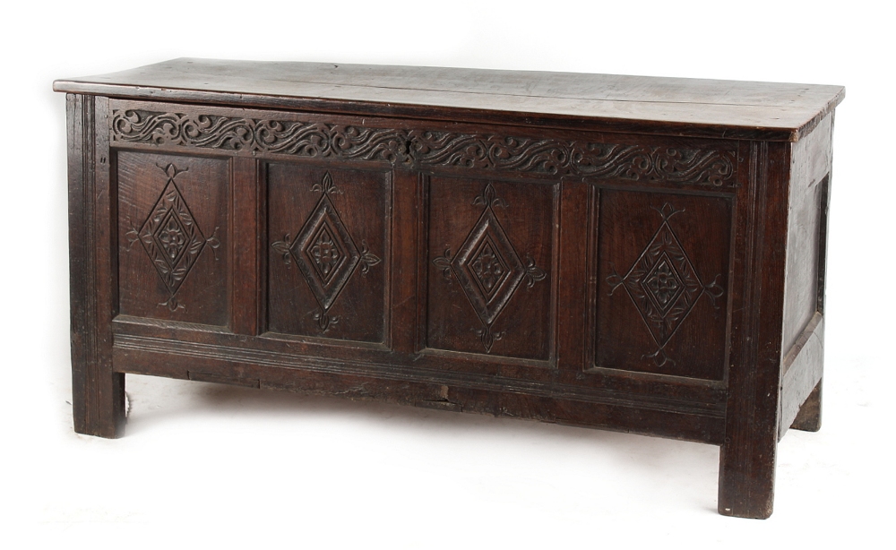Property of a lady - a 17th century carved oak coffer, with four panel front, 60.25ins. (153cms.)