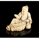 The Ronald Hart Collection of Japanese Netsukes - a carved ivory netsuke modelled as a recumbent