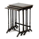 Property of a gentleman - a nest of three black painted occasional tables, on slender turned