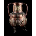 A Middle Eastern Islamic copper & brass two-handled vessel, 19.3ins. (49cms.) high (see
