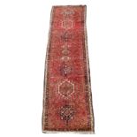 Property of a lady - a Hamadan runner, second half 20th century, with pale red ground, 120 by 32ins.