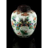 A Chinese famille verte ovoid ginger jar, late 19th century, painted with butterflies among