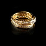 An unmarked yellow gold diamond set Russian wedding ring, the three linked rings set with round