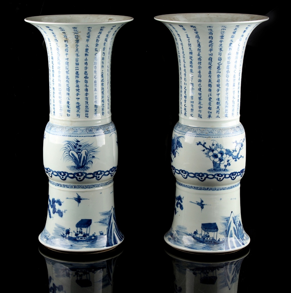 A pair of Chinese blue & white yen yen vases, each painted with calligraphy above a border of prunus