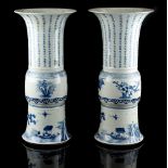 A pair of Chinese blue & white yen yen vases, each painted with calligraphy above a border of prunus