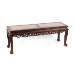 A Chinese carved hongmu rectangular topped table, circa 1900, the top inset with twin mottled pink