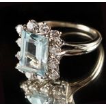 An unmarked white gold aquamarine & diamond ring, the rectangular cut aquamarine weighing an
